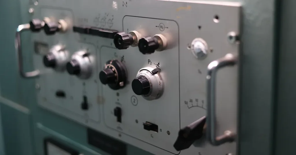 Labelled switches and dials on an industrial control panel