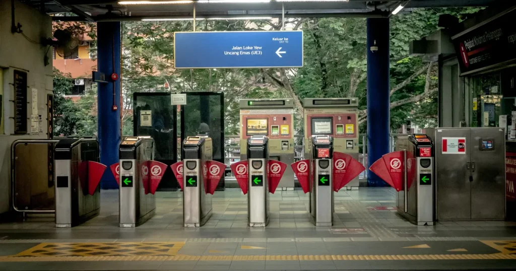Rows of closed ticket gates at the entrance of an empty urban transit station