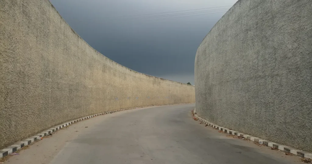 Tall concrete barriers narrowing a road, illustrating the Meta special ad category targeting limits