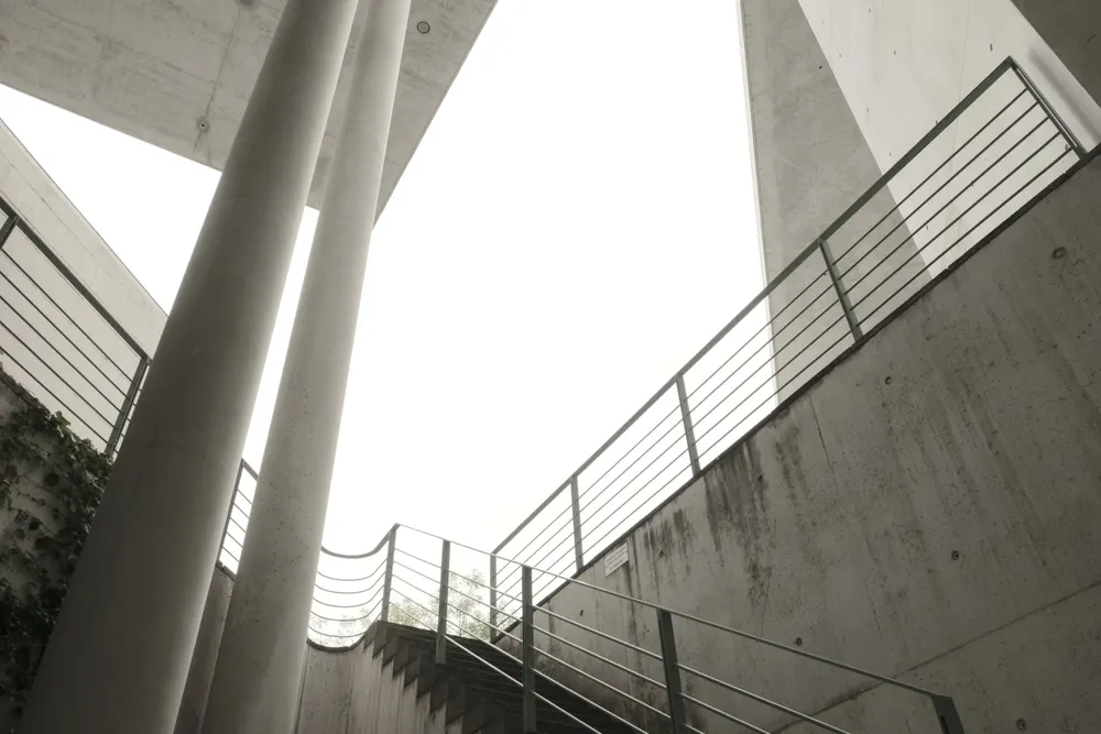 Concrete staircase rising between pillars, a visual for building a SaaS SEO strategy step by step