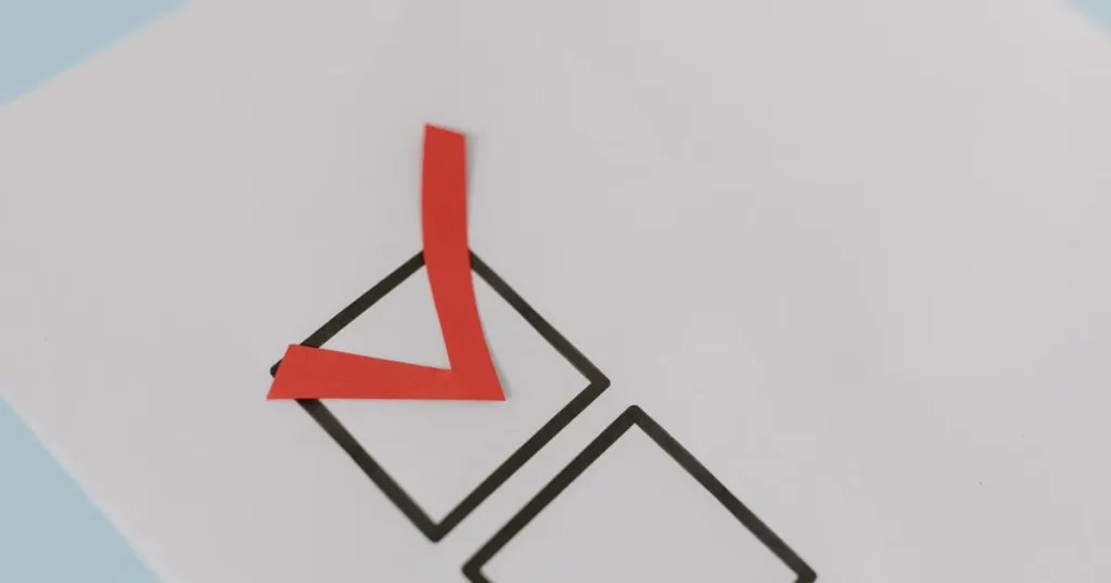 Red check mark ticking a box on a white checklist, the fintech marketing strategy sign-off