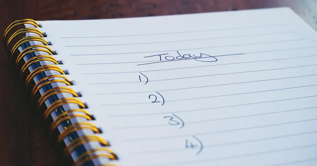 Handwritten numbered to-do list on a spiral notebook page, a simple checklist before writing a content brief template